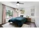 Comfortable bedroom with a large window, ceiling fan, and plush furnishings for a restful retreat at 9630 W 38Th Ave, Wheat Ridge, CO 80033