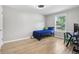 Bright bedroom featuring wood floors, a window with natural light, and a modern ceiling fan at 9630 W 38Th Ave, Wheat Ridge, CO 80033
