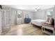 Bright bedroom featuring hardwood floors, neutral walls, and a window overlooking the backyard at 9630 W 38Th Ave, Wheat Ridge, CO 80033