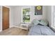 Cozy bedroom with wood floors, side table, and a window that brings in natural light at 9630 W 38Th Ave, Wheat Ridge, CO 80033