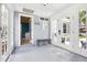 Inviting entryway featuring bright doors, a wooden bench, and stylish decor, creating a warm welcome at 9630 W 38Th Ave, Wheat Ridge, CO 80033