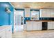 Bright kitchen with striking blue walls, wooden countertops, and modern appliances, blending style and functionality at 9630 W 38Th Ave, Wheat Ridge, CO 80033