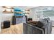 Living room features a large TV, modern shelving, and a comfortable sofa on hardwood floors at 9630 W 38Th Ave, Wheat Ridge, CO 80033