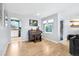 Bright living room features hardwood floors, a piano, and an open layout with views to the kitchen at 9630 W 38Th Ave, Wheat Ridge, CO 80033
