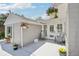 Cozy patio with hanging flower baskets and seating, perfect for relaxing and enjoying outdoor living at 9630 W 38Th Ave, Wheat Ridge, CO 80033