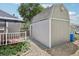Exterior view of grey shed with barn roof, stone landscaping, and proximity to patio at 9630 W 38Th Ave, Wheat Ridge, CO 80033