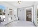 Bright sunroom featuring multiple windows, a door to the outside, and access to the laundry area at 9630 W 38Th Ave, Wheat Ridge, CO 80033