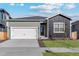 Charming single-story home with two-car garage, featuring mixed siding and landscaped front yard at 819 Sunflower Dr, Brighton, CO 80601