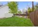 Large backyard with lush green lawn, a shed, privacy fence and patio seating at 12212 W 60Th Pl, Arvada, CO 80004