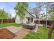 Backyard with lush lawn, patio seating, privacy fence and garden beds at 12212 W 60Th Pl, Arvada, CO 80004