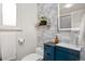 Stylish bathroom featuring a modern vanity, decorative wallpaper and sleek fixtures at 12212 W 60Th Pl, Arvada, CO 80004