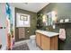 Inviting bathroom featuring wood paneling, modern fixtures and stylish decor at 12212 W 60Th Pl, Arvada, CO 80004