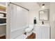 Clean and modern bathroom featuring a shower-tub, sleek vanity, and decorative mirror at 12212 W 60Th Pl, Arvada, CO 80004