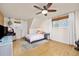 Bright bedroom featuring windows on two walls, ceiling fan and hardwood floors at 12212 W 60Th Pl, Arvada, CO 80004