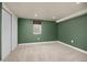 A bedroom with a soothing green palette, carpeted floors, and a practical sliding-door closet at 12212 W 60Th Pl, Arvada, CO 80004