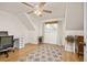 Bright bedroom with hardwood floors, a ceiling fan, and a cozy reading nook at 12212 W 60Th Pl, Arvada, CO 80004
