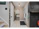 Stylish entryway with patterned tile flooring, decorative wallpaper, and a glimpse into the bright kitchen at 12212 W 60Th Pl, Arvada, CO 80004