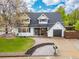 Two-story home with a well-maintained lawn, dormer windows, a cozy front porch, and a single-car garage at 12212 W 60Th Pl, Arvada, CO 80004