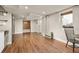 Inviting living area with laminate flooring, a large window, and access to other rooms at 12212 W 60Th Pl, Arvada, CO 80004