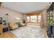 Cozy living room with a bay window, hardwood floors, comfortable seating, and natural light at 12212 W 60Th Pl, Arvada, CO 80004