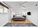 Comfortable main bedroom with ample natural light, hardwood floors and ceiling fan at 12212 W 60Th Pl, Arvada, CO 80004