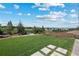Serene backyard with a well-manicured lawn and a distant mountain view at 372 Castlemaine Ct, Castle Rock, CO 80104