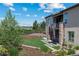 Landscaped backyard with a spiral staircase and stone accents leading to a balcony at 372 Castlemaine Ct, Castle Rock, CO 80104