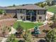 Aerial view of a home with a lush backyard, spiral staircase, and stone detailing at 372 Castlemaine Ct, Castle Rock, CO 80104