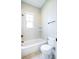 Bright bathroom with white fixtures, a shower-tub combination, and minimalist design at 372 Castlemaine Ct, Castle Rock, CO 80104