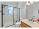 Well-lit bathroom featuring a glass-enclosed shower, a vanity with a sink, and a toilet at 372 Castlemaine Ct, Castle Rock, CO 80104