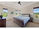 Primary bedroom with tray ceiling, many windows, and a neutral color palette at 372 Castlemaine Ct, Castle Rock, CO 80104