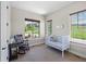 Bright Bedroom featuring two large windows, a rocking chair, and a white crib at 372 Castlemaine Ct, Castle Rock, CO 80104