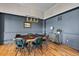 Stylish dining room with a live-edge wood table, designer lighting, and elegant decor at 372 Castlemaine Ct, Castle Rock, CO 80104