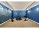 Dedicated home gym featuring weightlifting equipment and painted mountain mural at 372 Castlemaine Ct, Castle Rock, CO 80104
