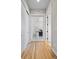 Bright hallway with wood floors, white trim, and glass-paneled doors leading to other rooms of the home at 372 Castlemaine Ct, Castle Rock, CO 80104