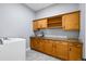 Laundry room with granite countertop, wooden cabinets and utility sink at 372 Castlemaine Ct, Castle Rock, CO 80104
