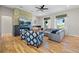 Bright living room featuring a stone fireplace, hardwood floors, and a comfortable sectional couch at 372 Castlemaine Ct, Castle Rock, CO 80104