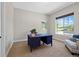Bright office with a blue desk, neutral walls, and a window offering natural light and neighborhood views at 372 Castlemaine Ct, Castle Rock, CO 80104