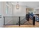 Modern staircase with black metal railings, wood steps, and a view into the living room on the upper level at 372 Castlemaine Ct, Castle Rock, CO 80104