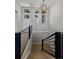 Staircase with modern lighting fixture and black metal railing at 372 Castlemaine Ct, Castle Rock, CO 80104