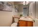 Charming powder room featuring a wood vanity, decorative mirror, and wall art at 3779 Aspen Hollow Ct, Castle Rock, CO 80104