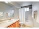 Bright bathroom features a sink, toilet, shower-tub combo, and neutral-colored tile flooring at 3779 Aspen Hollow Ct, Castle Rock, CO 80104