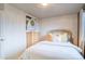 Comfortable bedroom with light walls, a dresser, and a queen-size bed with colorful pillows at 3779 Aspen Hollow Ct, Castle Rock, CO 80104