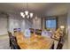 Open-concept dining area adjacent to the living room and featuring a carpeted staircase at 3779 Aspen Hollow Ct, Castle Rock, CO 80104