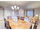 Warm dining area with a wood table for six, chandelier, and views into the cozy living room at 3779 Aspen Hollow Ct, Castle Rock, CO 80104