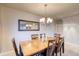 Dining room featuring a wood table with seating for six, modern lighting, and a decorative mirror at 3779 Aspen Hollow Ct, Castle Rock, CO 80104