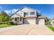 Charming home featuring an inviting front porch and a spacious three-car garage, nestled on a well-manicured lawn at 3779 Aspen Hollow Ct, Castle Rock, CO 80104