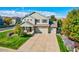Well-manicured home featuring a three-car garage, green lawn, and mature landscaping at 3779 Aspen Hollow Ct, Castle Rock, CO 80104