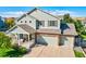 Charming two-story home with a welcoming front porch and a three-car garage at 3779 Aspen Hollow Ct, Castle Rock, CO 80104