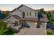 Inviting two-story home featuring a three-car garage, cozy porch, and attractive exterior at 3779 Aspen Hollow Ct, Castle Rock, CO 80104